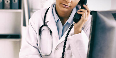 Female doctor calling on phone