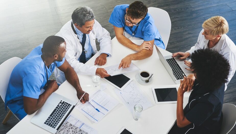Group of doctors in discussion at a board room table