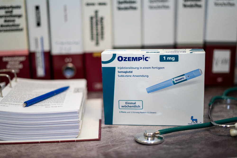 A box of Ozempic sitting next to a stethoscope